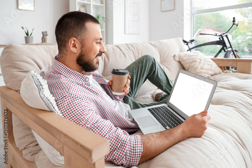 Freelancer lying on sofa an...