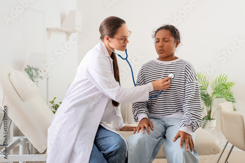Pediatric doctor examining ...