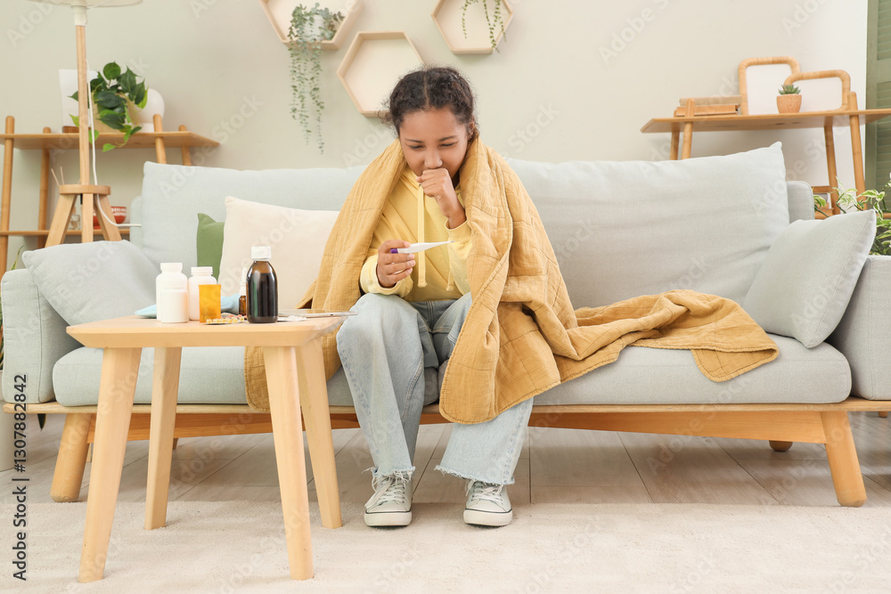 Sick African-American girl checking temperature at home Sick African-American girl checking temperature at home