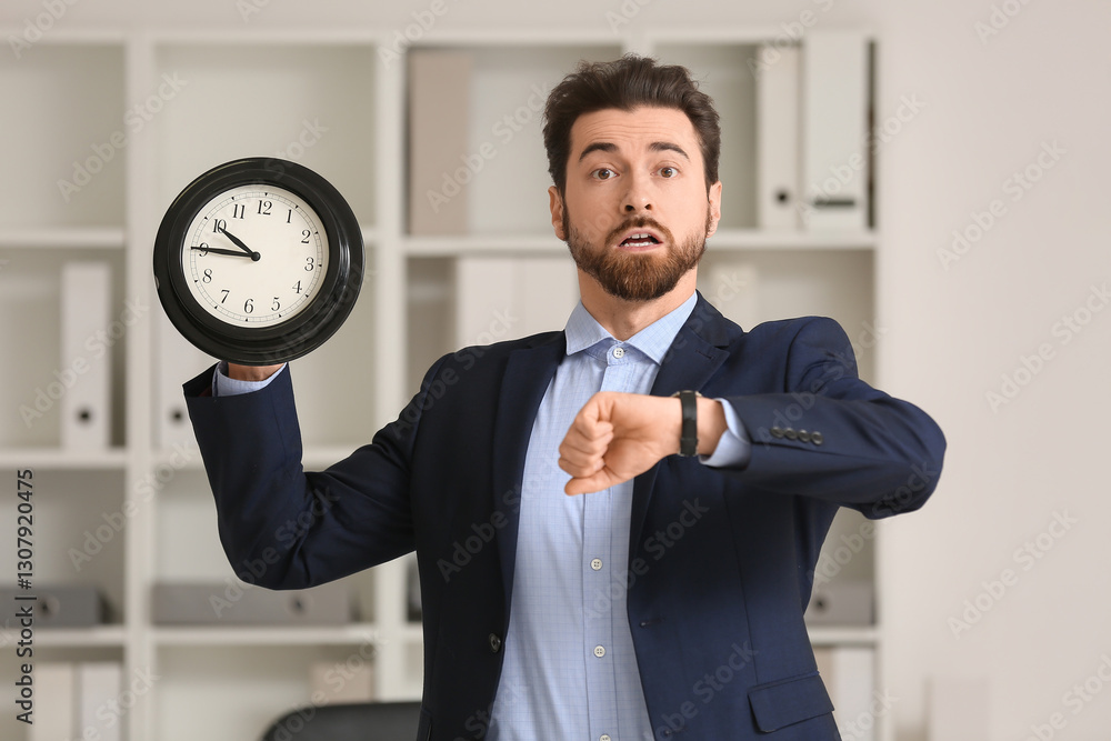 Stressed businessman looking at his watch and holding clock in office, Deadline concept Stressed businessman looking at his watch and holding clock in office, Deadline concept
