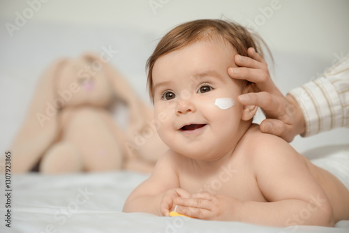Mother applying cream on he...