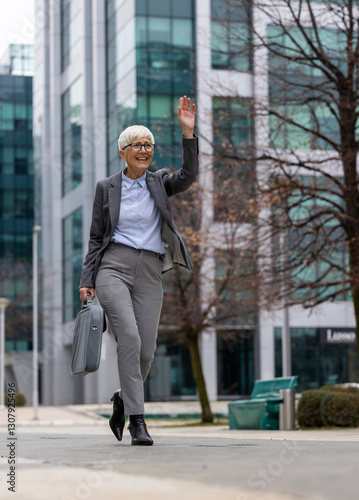 Professional woman walking with briefcase in city