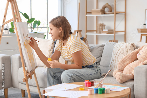 Teenage girl painting with ...