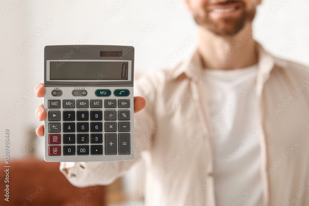 Smiling businessman with grey modern calculator in office Smiling businessman with grey modern calculator in office