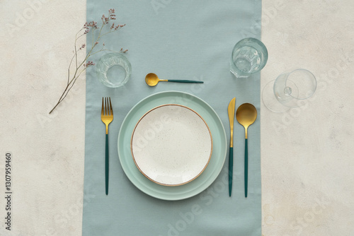 Stylish table setting with blue cloth on white background. Top view