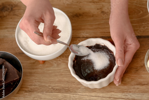 Female hands adding spoon o...