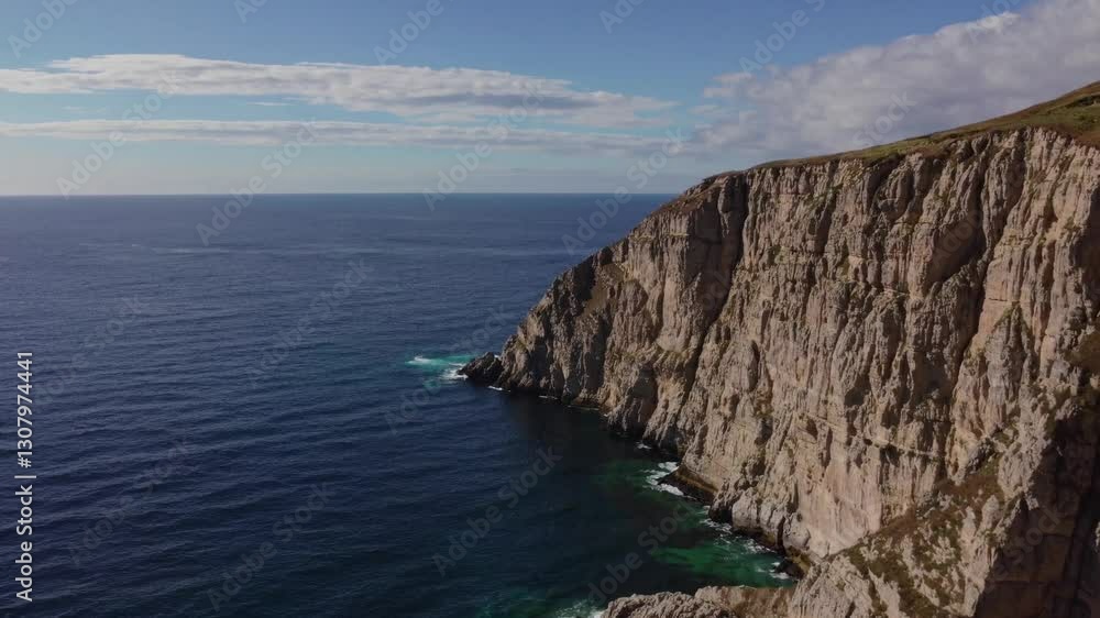 A Breathtaking Coastal View of Rugged Cliffs Dramatically Plunging into the Deep Blue Sea – Highlighting the Powerful Contrast Between the Rocky Shoreline and Calm Ocean in a Striking Natural A Breathtaking Coastal View of Rugged Cliffs Dramatically Plunging into the Deep Blue Sea – Highlighting the Powerful Contrast Between the Rocky Shoreline and Calm Ocean in a Striking Natural