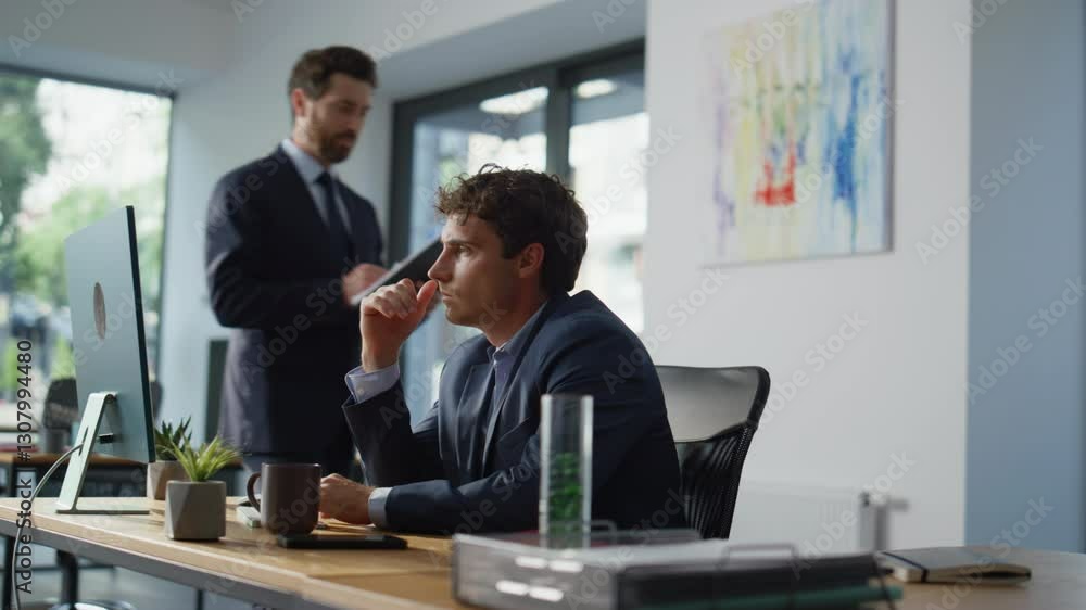 Focused man looking monitor at office closeup. Businessman consulting colleague Focused man looking monitor at office closeup. Businessman consulting colleague