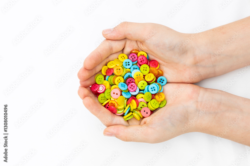 Handful of multi-colored buttons in the hands Handful of multi-colored buttons in the hands