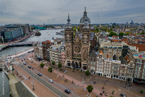 Canvas Print Beautiful aerial view of Amsterdam Stichting Muziek in de Nicolaas near the Centraal Train Station and its historic hub with canals, bikes, cafes