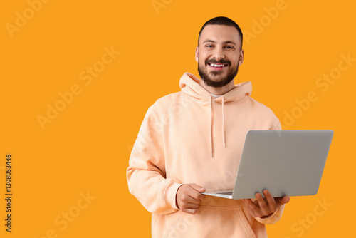 Smiling young man with lapt...