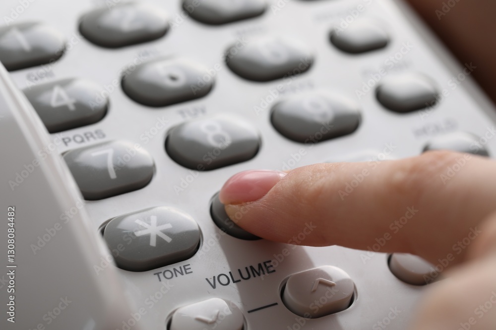 Woman dialing number on landline telephone, closeup Woman dialing number on landline telephone, closeup
