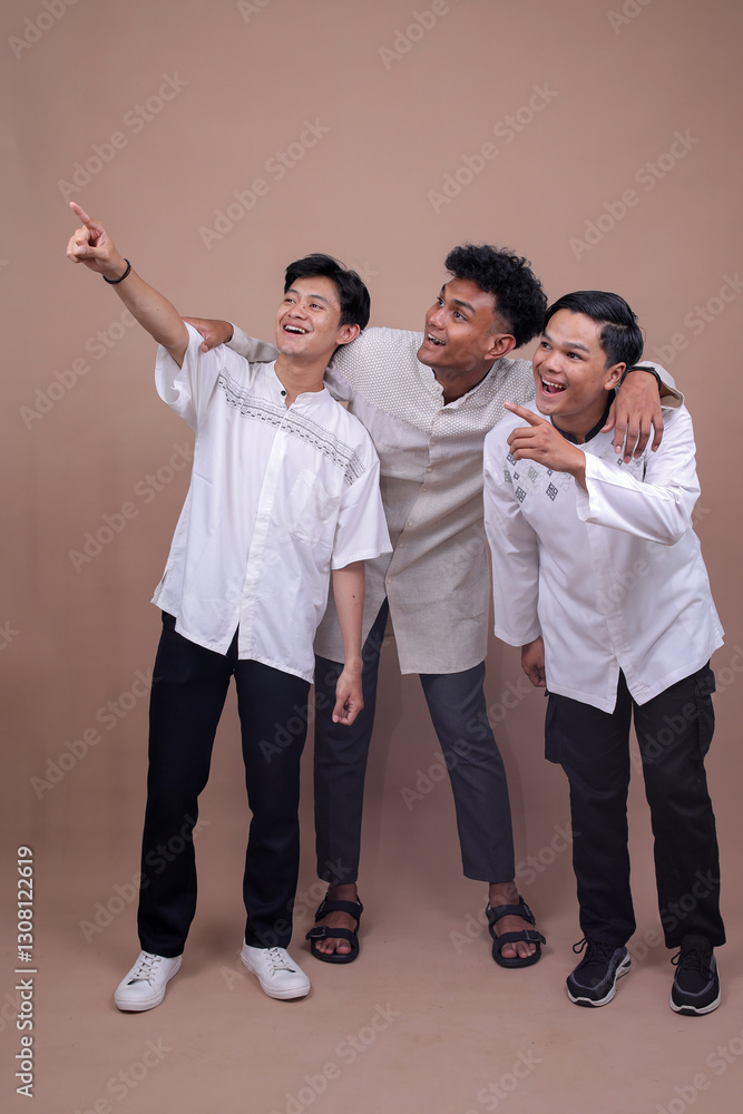 Full Length Shot of Diverse Muslim Friends Pointing at Something Isolated on Beige Background Full Length Shot of Diverse Muslim Friends Pointing at Something Isolated on Beige Background