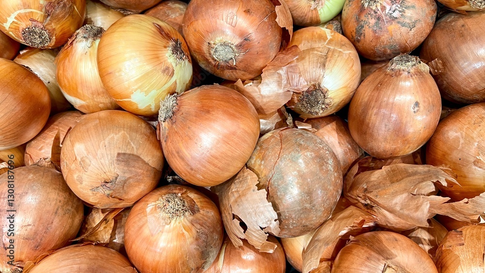 Vibrant fresh onions (Allium Cepa Linnaeus) stacked at the sale in supermarket. In Indonesia these onions are called bawang bombai. Many of Indonesian cuisine using this spice. Vibrant fresh onions (Allium Cepa Linnaeus) stacked at the sale in supermarket. In Indonesia these onions are called bawang bombai. Many of Indonesian cuisine using this spice.