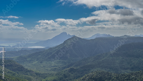 Wallpaper Mural Beautiful panoramic mountain landscape. There is a lush green vegetation, a tropical forest on the slopes and in the valley. Lakes, the ocean are visible in the distance. Blue sky, clouds. Mauritius Torontodigital.ca