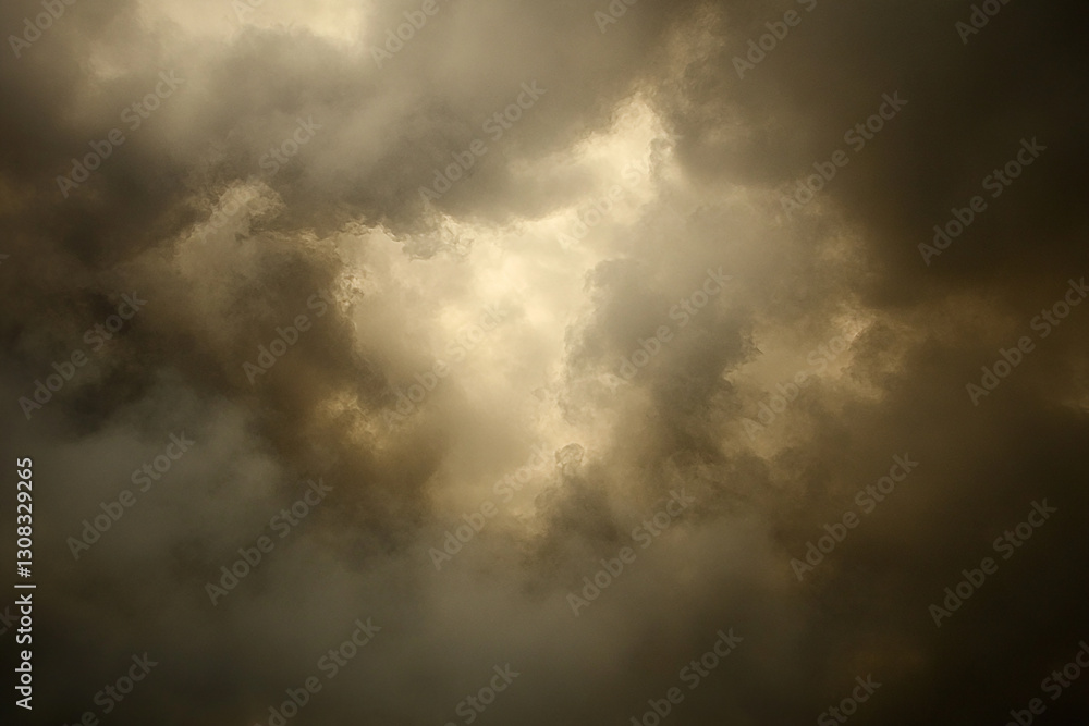 Fototapeta premium Dramatic sky filled with dark clouds, hinting at an impending storm, with light breaking through