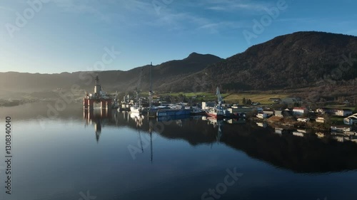 Wallpaper Mural Evening aerial over Westcon Shipyard in Olensvag, Norway. Drilling rig and ships moored, glossy sea surface reflecting soft light Torontodigital.ca