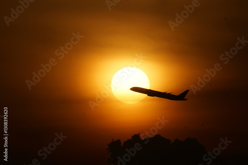 Aircraft rising along the rising sun