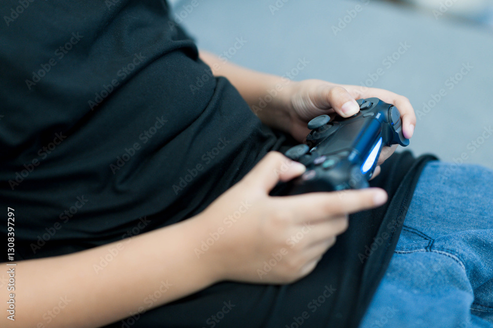 child playing video games with black game controller, focused and engaged. setting is casual, showcasing relaxed gaming environment child playing video games with black game controller, focused and engaged. setting is casual, showcasing relaxed gaming environment