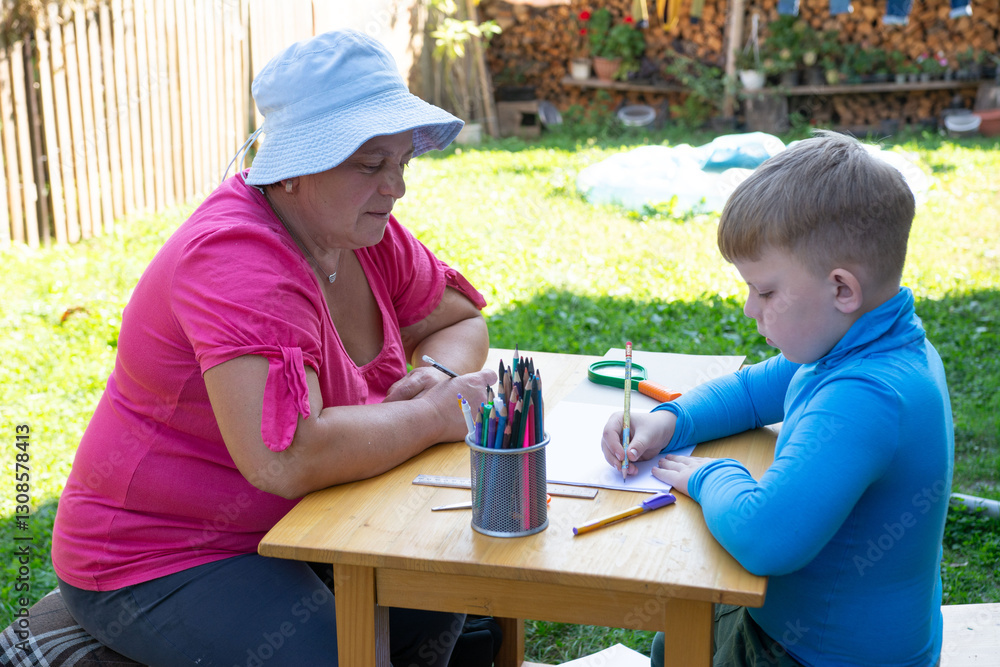 This image captures a child drawing at an outdoor table with an adult assisting or observing. Surrounded by a vibrant garden, it's a snapshot of learning and creative expression in a natural setting.