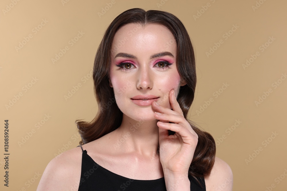 Portrait of beautiful young woman with stylish makeup and gorgeous hair on beige background Portrait of beautiful young woman with stylish makeup and gorgeous hair on beige background