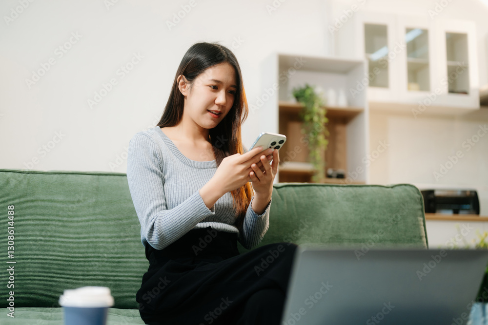Asian woman using the smartphone and tablet on the sofa at home. Asian woman using the smartphone and tablet on the sofa at home.