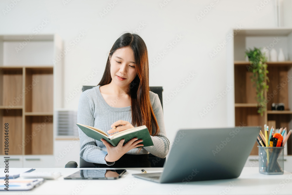 Asian Businesswoman Analyzing Finance on Tablet and Laptop at modern Office Desk Asian Businesswoman Analyzing Finance on Tablet and Laptop at modern Office Desk