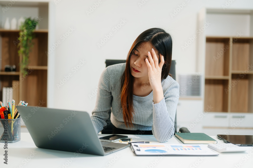 Asian business woman is stressed, bored, and overthinking from working on a tablet
