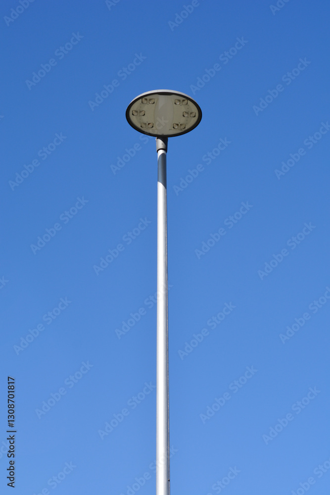 A minimalist shot of a single solar street light against a clear blue sky A minimalist shot of a single solar street light against a clear blue sky