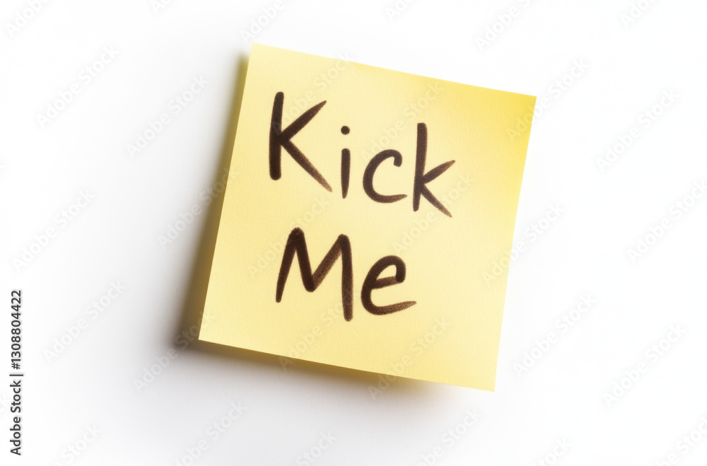 Sticky note with handwritten text kick me symbolizing prank or humor in practical jokes, April Fools day concept Sticky note with handwritten text kick me symbolizing prank or humor in practical jokes, April Fools day concept