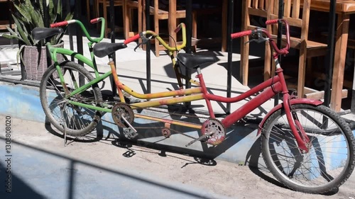 Tandem bicycle with bright colours on Koh Lipe street in Thailand.