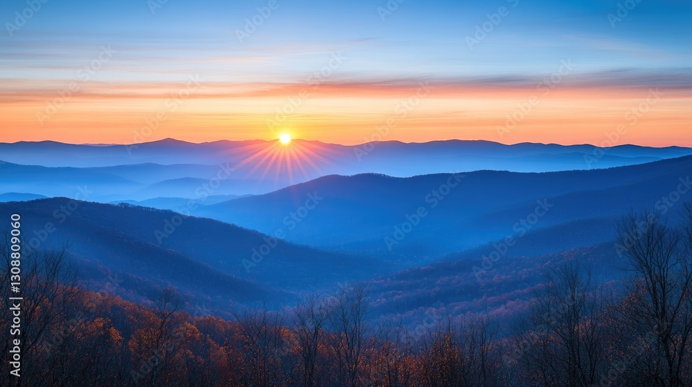 Fototapeta premium A beautiful sunrise illuminates layered mountain ranges at dawn