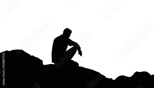 Silhouette of a thoughtful man sitting on a rock