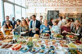 A diverse group of people, including women and men of various ethnicities, enjoy a buffet at a social event with conversation while selecting delicious food options. Corporate event with buffet