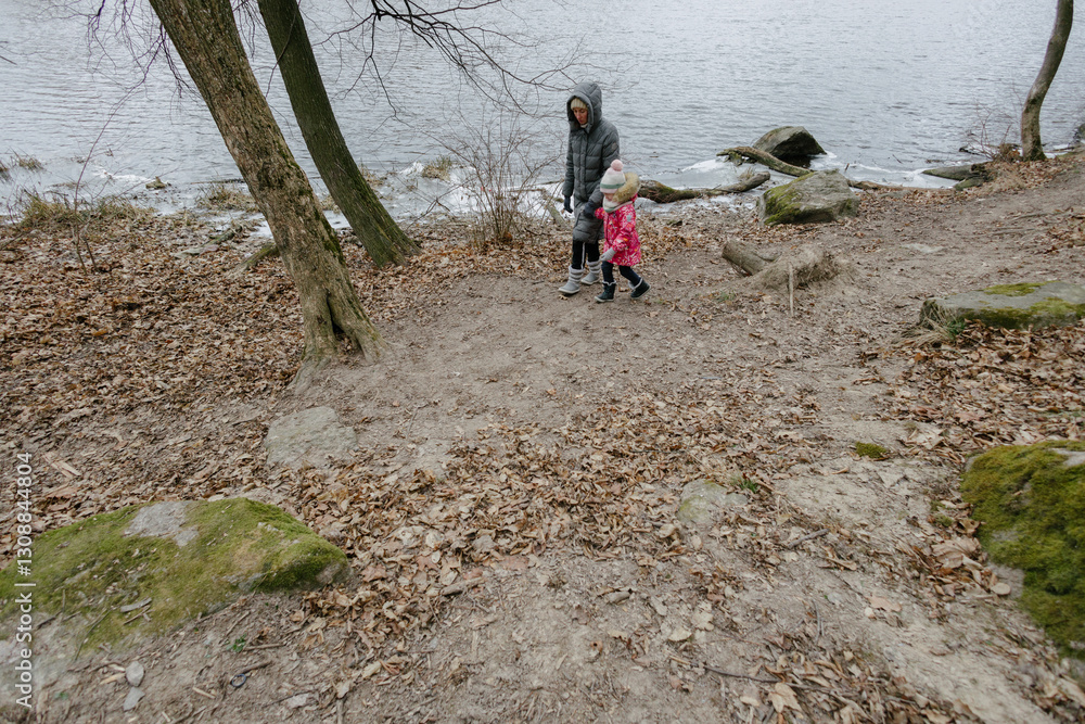 Mother and a child girl hiking in the forest Mother and a child girl hiking in the forest