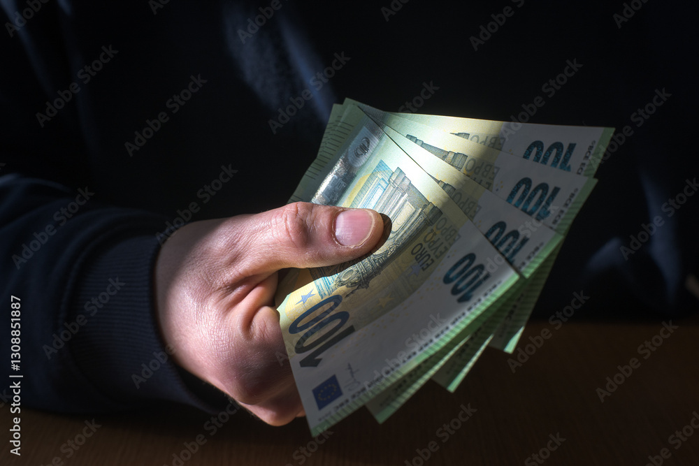 Man holding money in hand, euro currency.