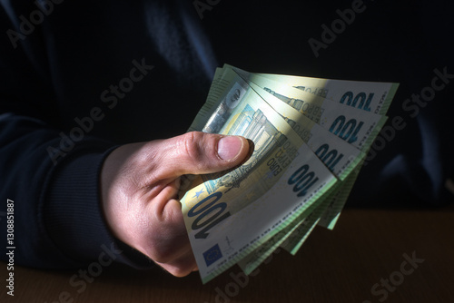 Obraz na płótnie Man holding money in hand, euro currency.
w salonie