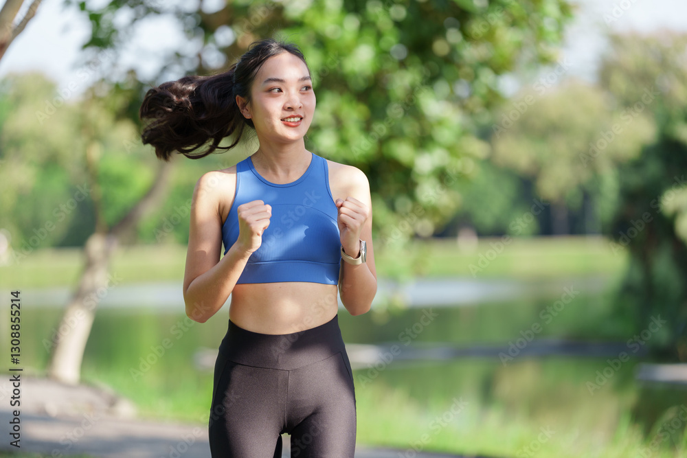 Happy sporty young asian woman running along a serene lake in a lush green park, relishing her outdoor workout while promoting a vibrant, healthy, and active lifestyle Happy sporty young asian woman running along a serene lake in a lush green park, relishing her outdoor workout while promoting a vibrant, healthy, and active lifestyle