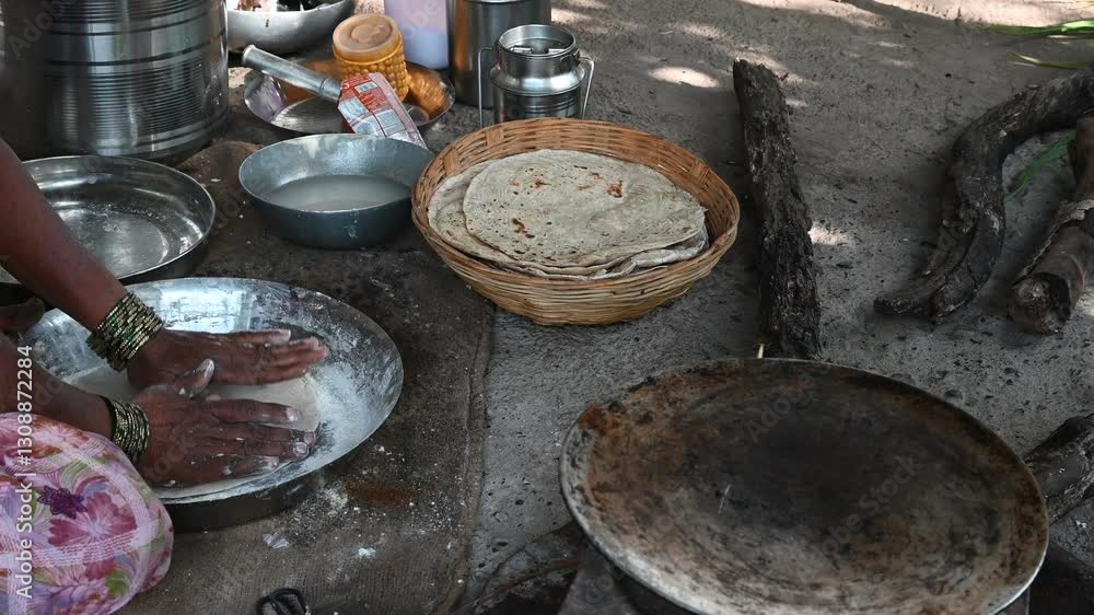 Poor woman in village cooking food. Indian village women pilgrims cooking food traditional. Bread from the village Poor woman in village cooking food. Indian village women pilgrims cooking food traditional. Bread from the village