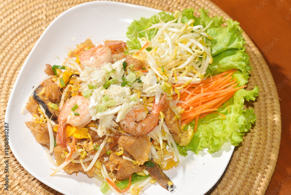 Stir-fried noodles with chicken and seafood, Close up shot Stir-fried noodles with chicken and seafood, Close up shot