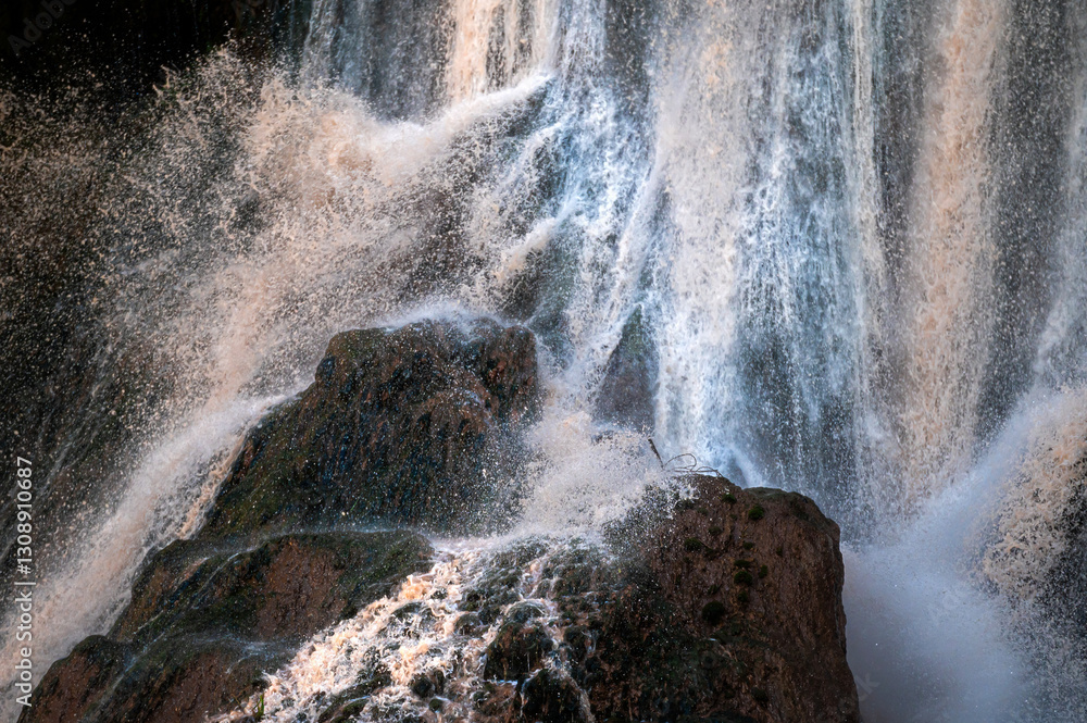 Majestic waterfalls cascade down rocky cliffs in Ouzoud, Morocco during bright daylight