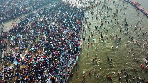 Aerial view of Huge crowd at Triveni Sangam in Prayagraj, India during Maha Kumbh. Kumbh Mela is the most important event, where millions of devotees, including Sadhu take a sacred holy dip in Ganga.