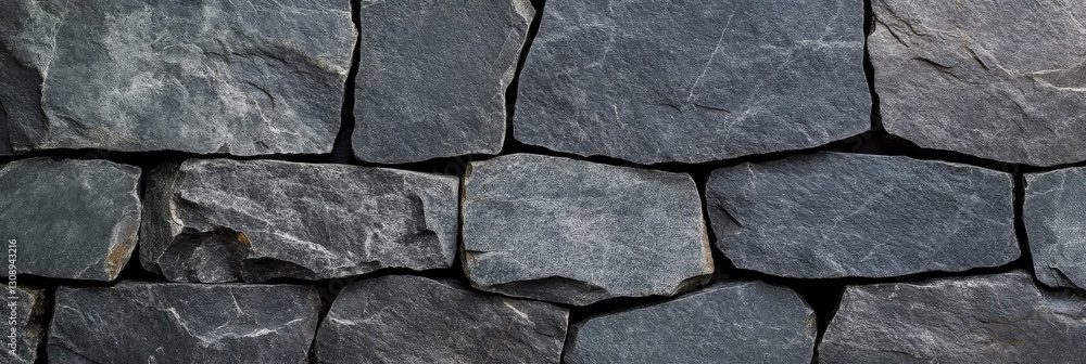 A closeup view of a stone wall with closely arranged bricks A closeup view of a stone wall with closely arranged bricks