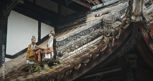 Chengdu, Sichuan, China. Figurines On Roof Of Temple. Chinese Architecture. Figurine Of Men Sitting At Table. Park On Grounds Of Wuhou Memorial Temple, Chengdu. Traditional Chinese Architectural