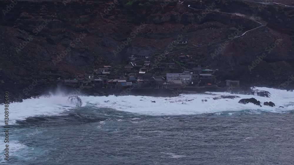 Stormy ocean waters batter the rugged shoreline of Pozo de Las Calcosas, Spain Stormy ocean waters batter the rugged shoreline of Pozo de Las Calcosas, Spain