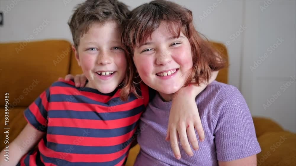 Joyful moments of friendship and laughter between siblings indoors Joyful moments of friendship and laughter between siblings indoors