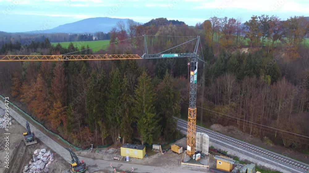Lowering aerial shot of crane installing block ramps on Salzach River, Salzburg