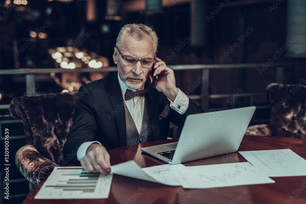 Old Businessman Working Late and talking on Phone Old Businessman Working Late and talking on Phone