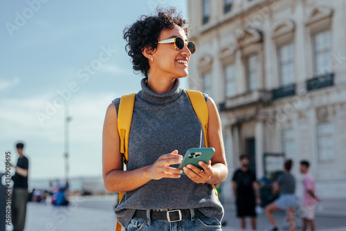 Tourist using smart phone and exploring city during summer vacation