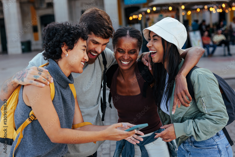 © bernardbodo - Group of diverse friends laughing together while looking at smart phone © bernardbodo - Group of diverse friends laughing together while looking at smart phone